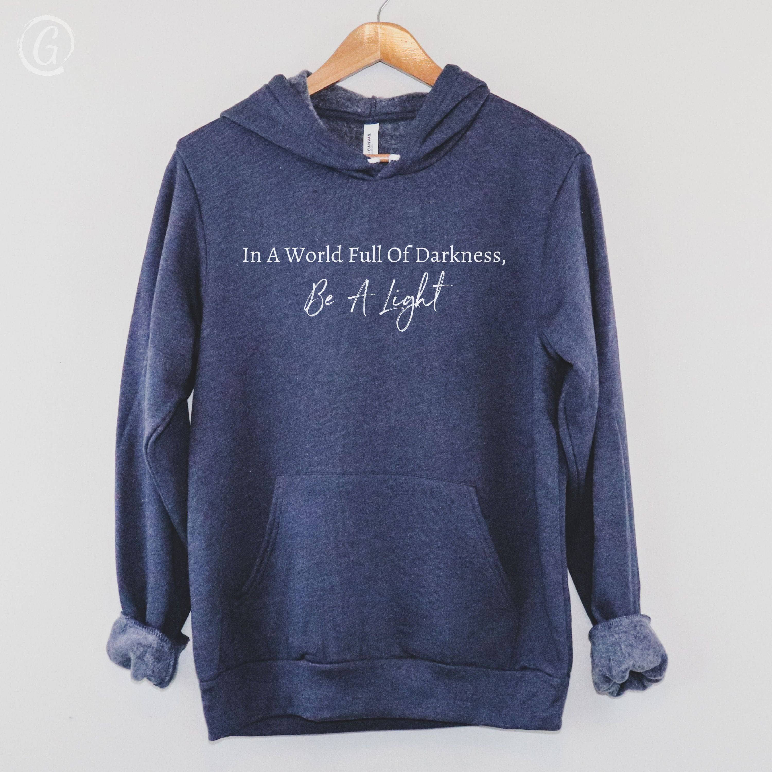 In A World Full Of Darkness, Be A Light Premium Unisex Pullover Hoodie Heather Navy