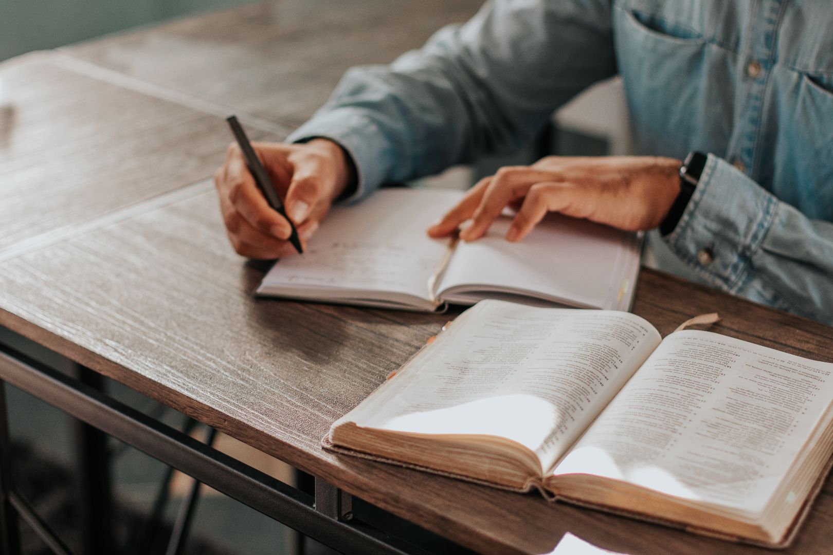 man taking notes during bible study